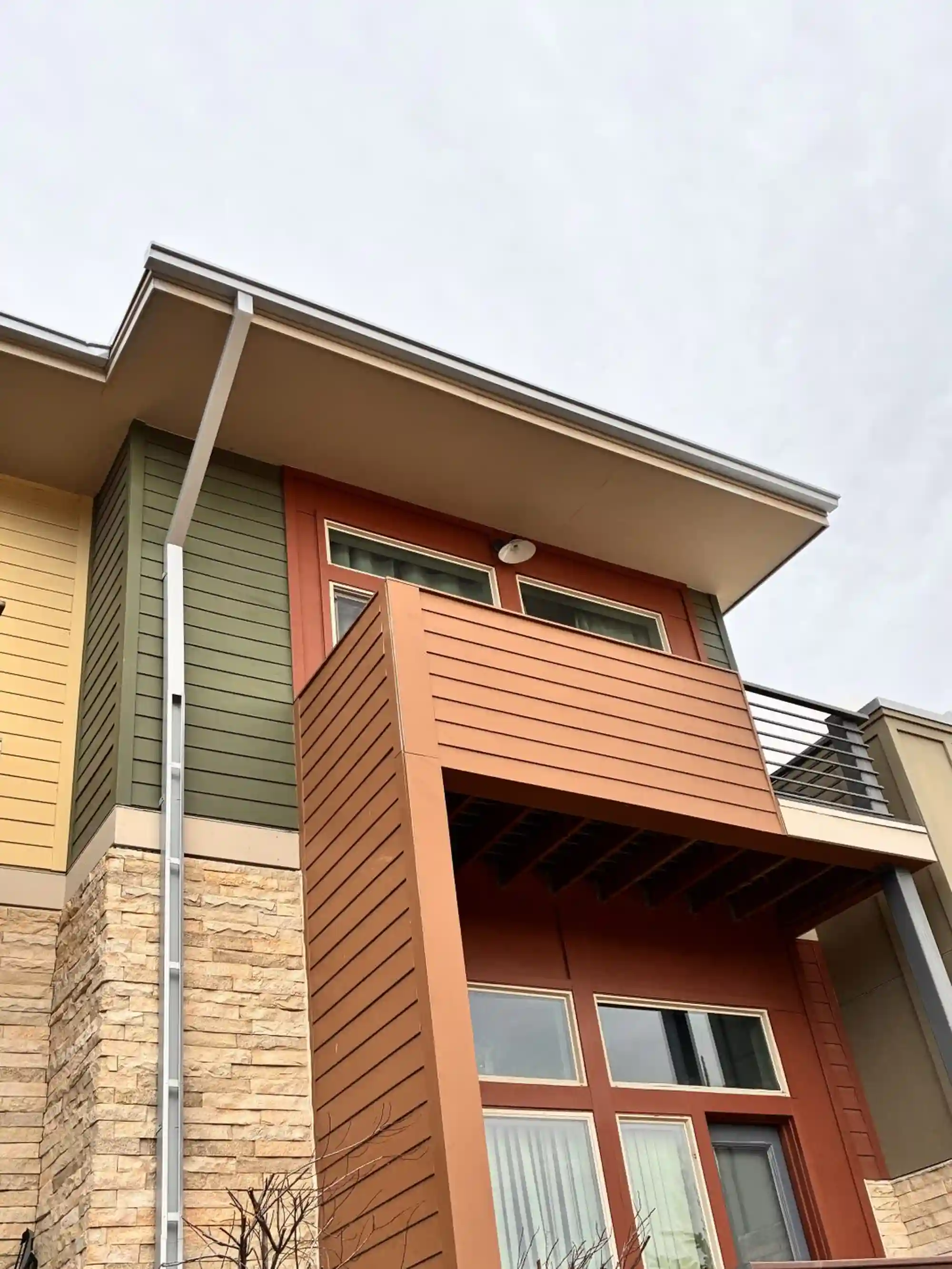 Multifamily building gutter and downspout